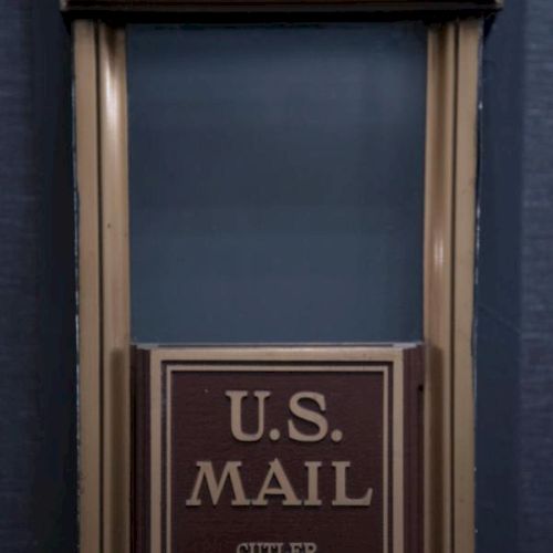 The image shows a vintage U.S. Mail drop box by Cutler Mailing System, with 